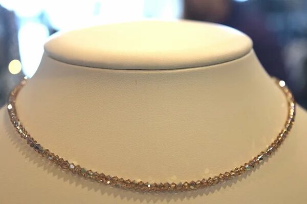 A 13-18" Light Colorado Necklace/Choker made of gold and diamonds on a mannequin.