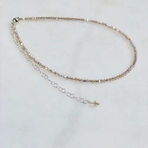 A 13-18" Light Silk Necklace/Choker with a silver chain and crystals.