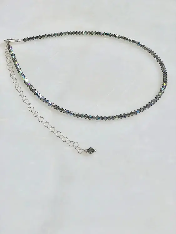 A 13 18" Black Diamond Necklace/Choker with a silver chain.
