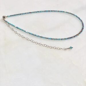 A 13-18 Turquoise X2 3mm Choker/Necklace with a silver chain.