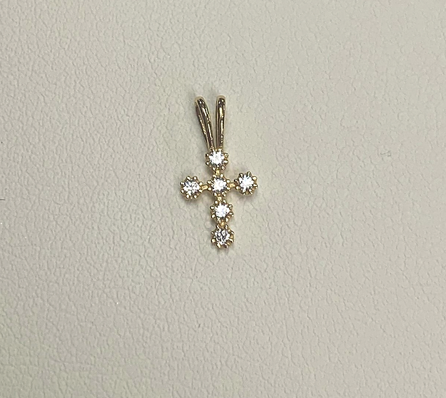 A 14K Yellow gold bezel set CZ cross pendant with diamonds on it.