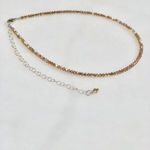 A 13-18" Light Colorado Necklace/Choker with a silver chain and a gold bead.