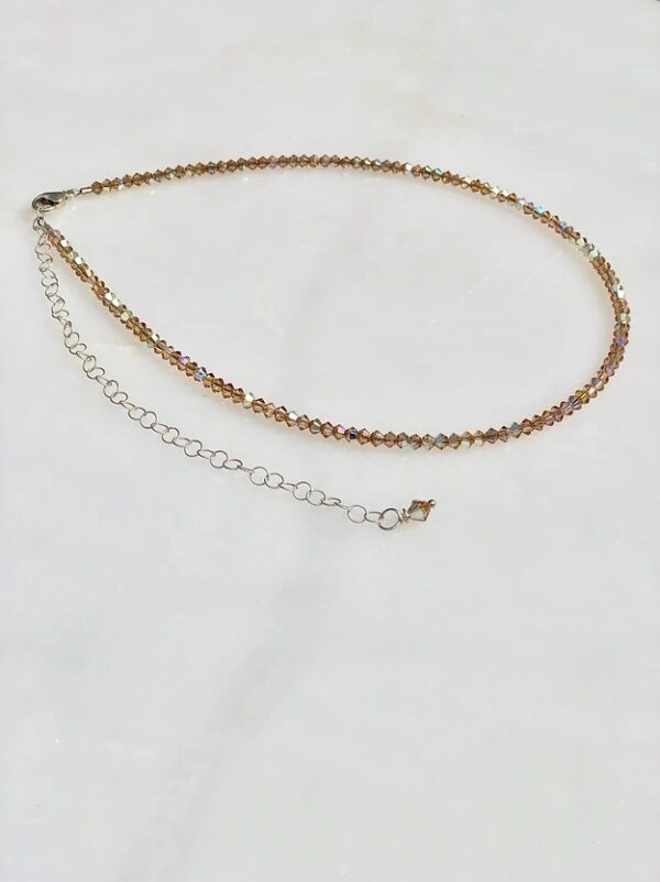 A 13-18" Light Colorado Necklace/Choker with a silver chain and a gold bead.