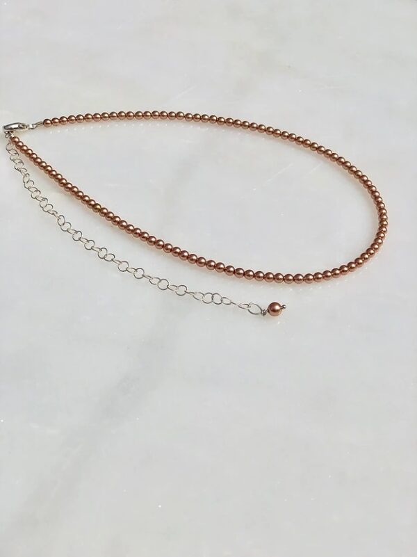 A necklace with a 13-18" Rose Gold Pearl Necklace/Choker and a silver chain.