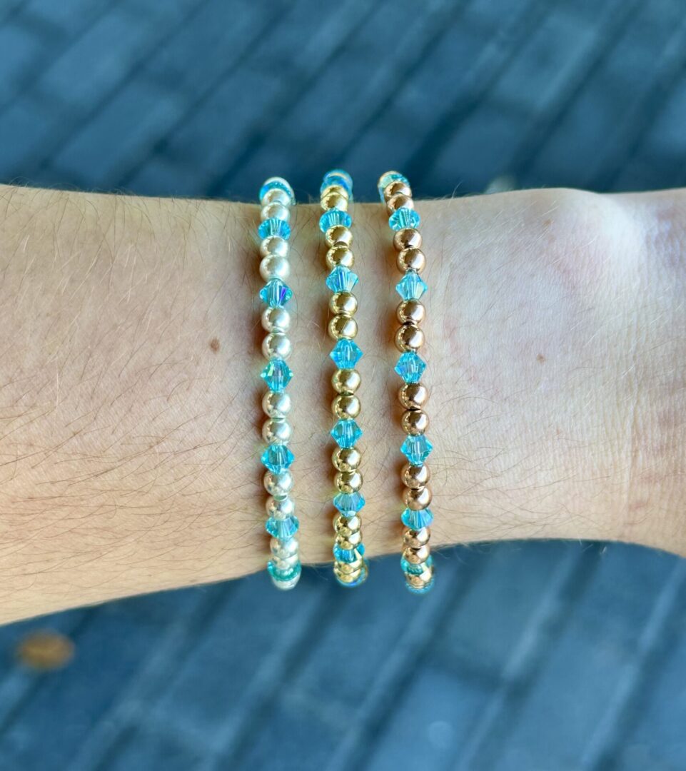 Two December Birthstone - Turquoise Crystal Stretch Bracelets on a woman's wrist.