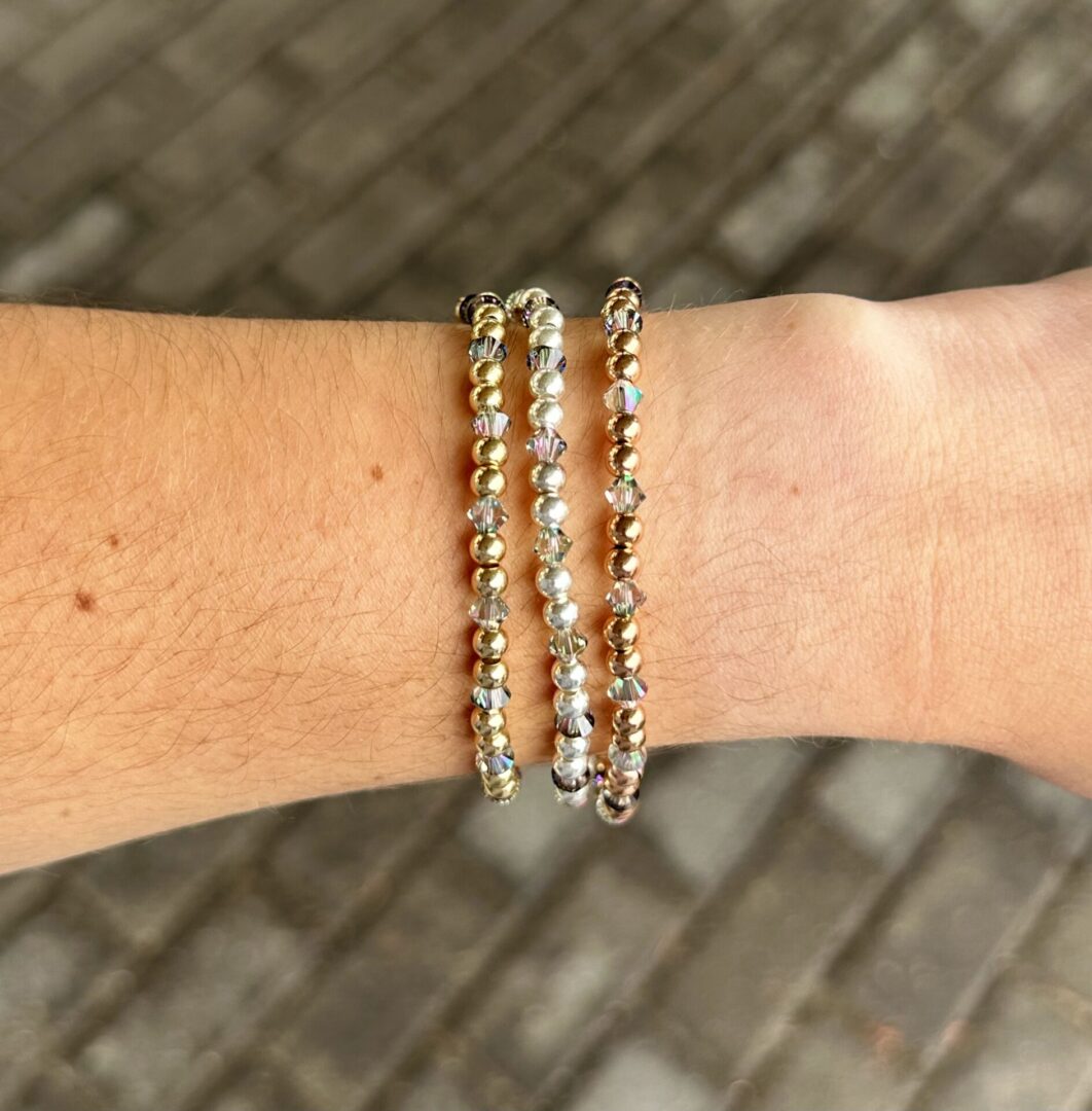 Three June Birthstone - Alexandrite Crystal Stretch Bracelets on a woman's wrist.