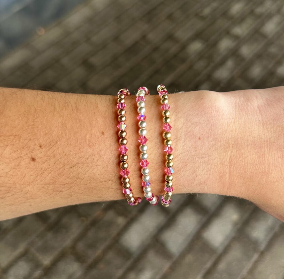 Three October Birthstone - Pink Tourmaline Crystal Stretch Bracelets on a woman's wrist.