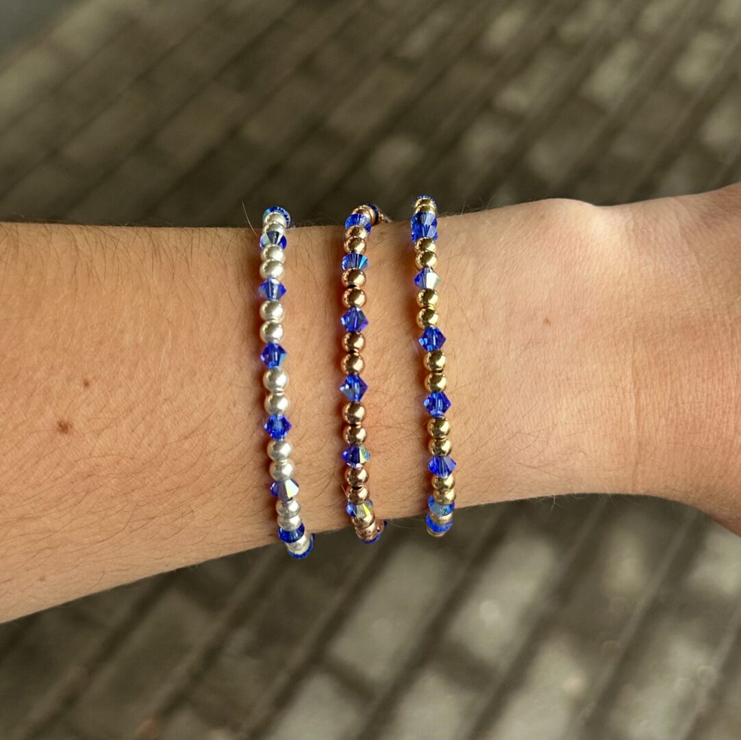 Three Sapphire Crystal Stretch Bracelets on a person's wrist.