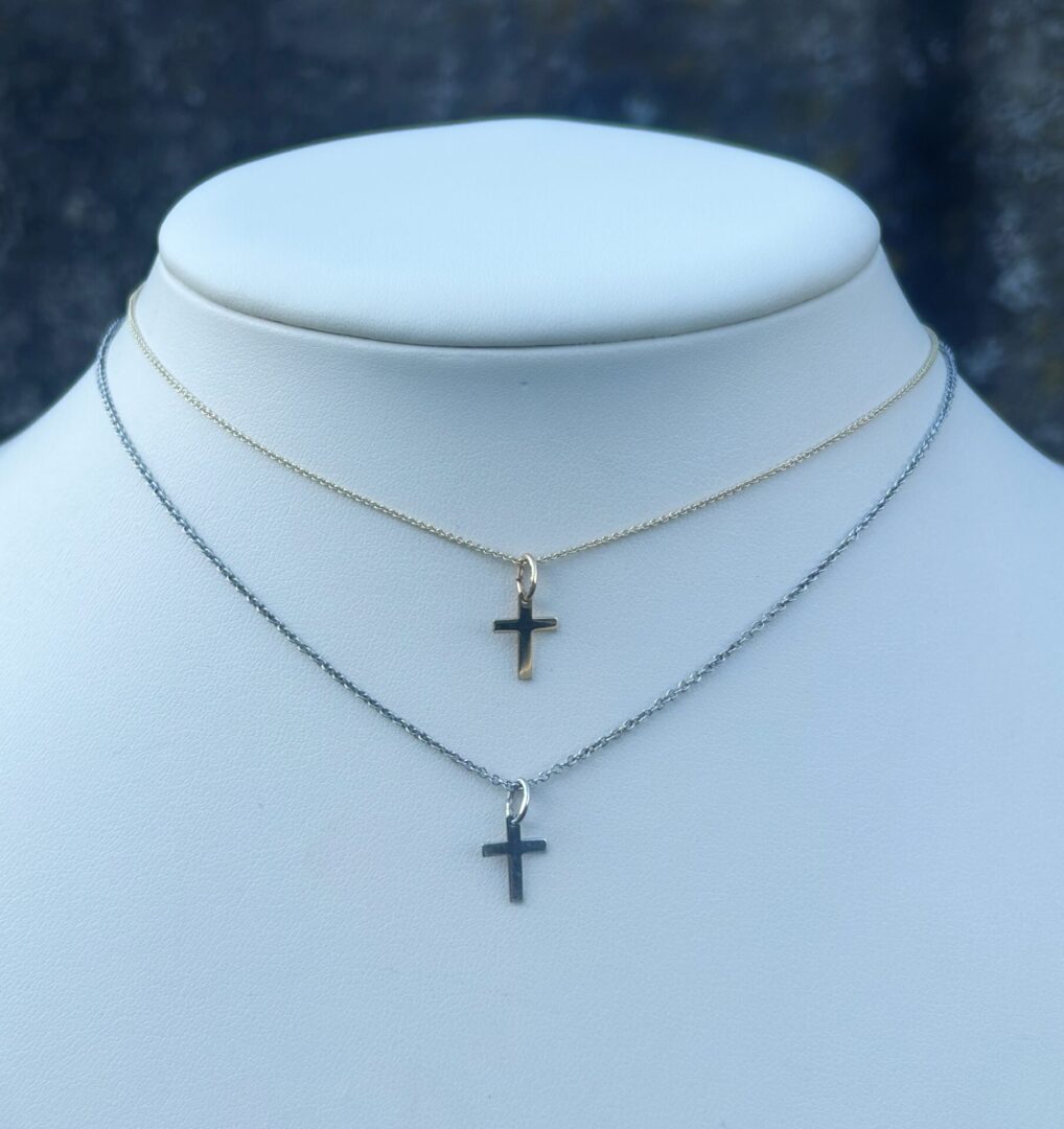 Two KIDS 10mm Cross Necklaces on a mannequin.