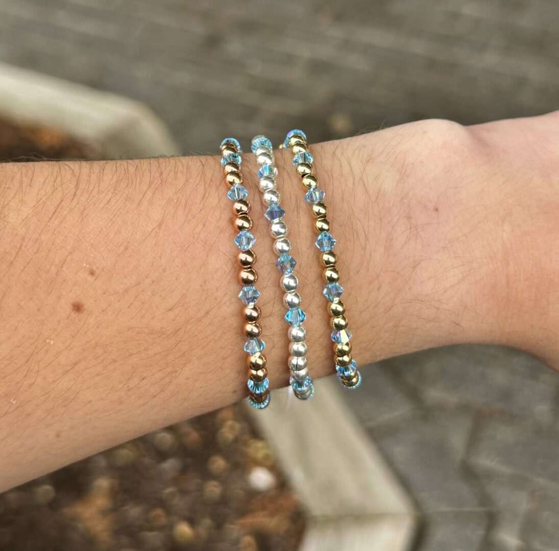 Three March Birthstone - Aquamarine Crystal Stretch Bracelets on a woman's wrist.