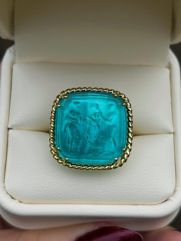 A person is holding a Gold Venetian Glass Ring in a box.
