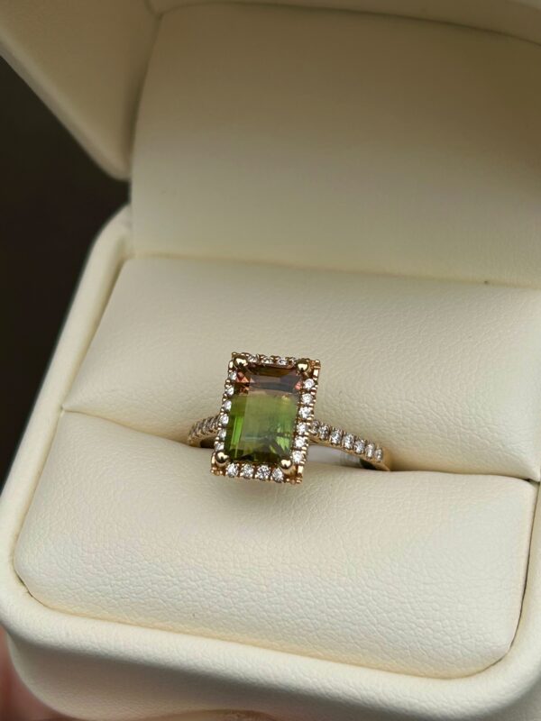A Watermelon Tourmaline and Diamond Gold Ring in a box.