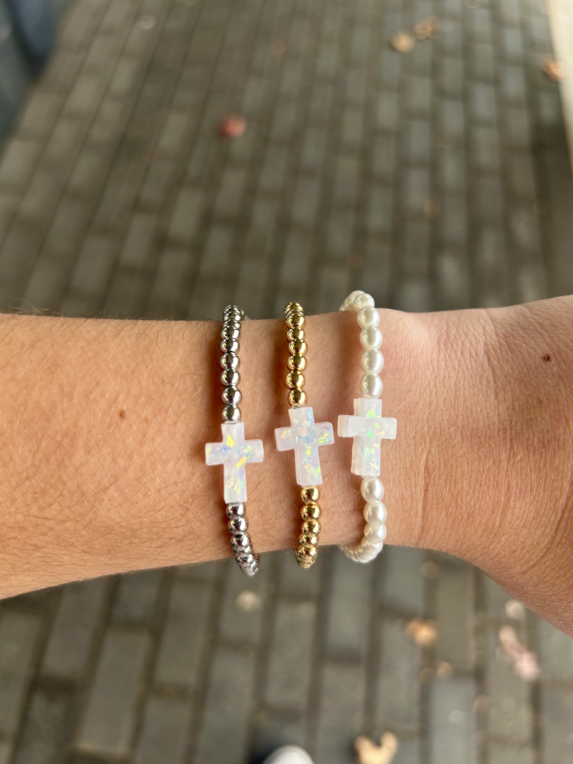 Three Holy Water bracelets on a woman's wrist.