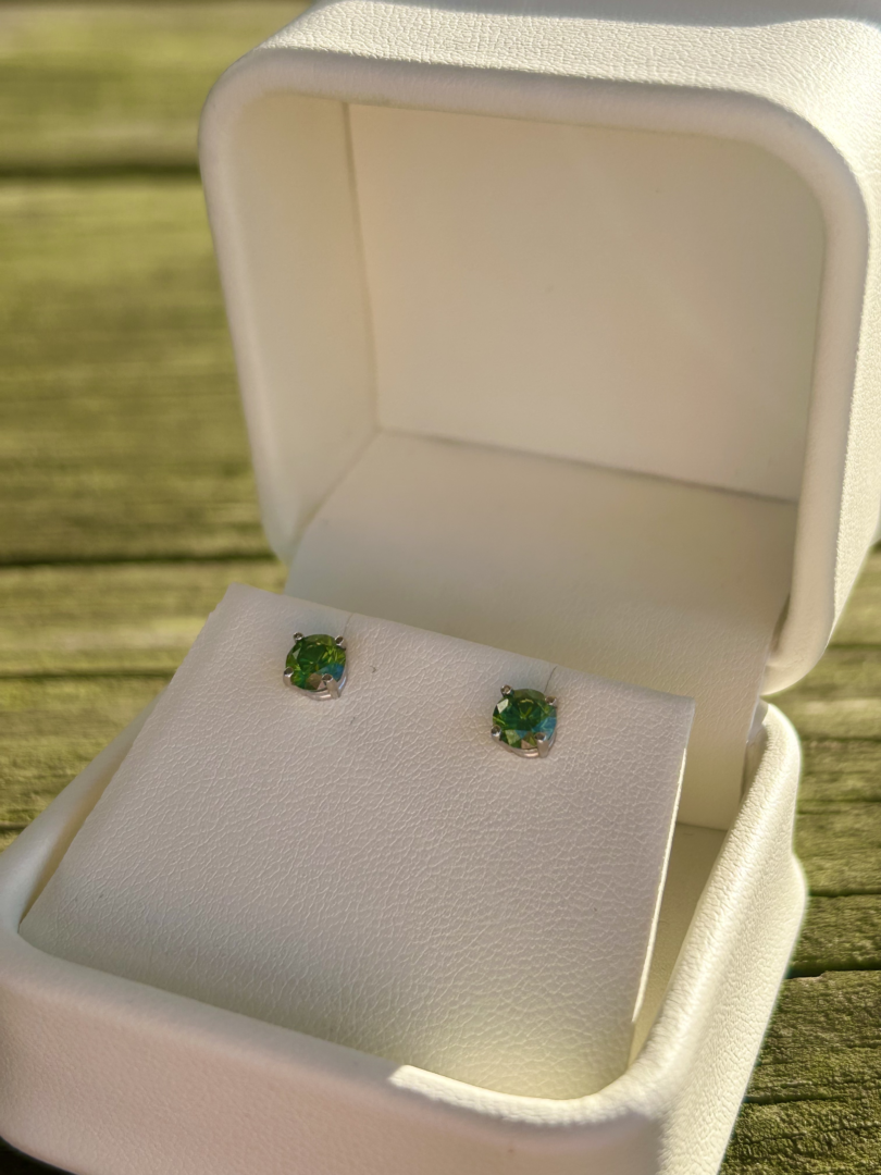White Gold Green Diamond Studs in a white box.