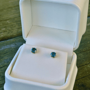 Gold Blue Diamond Studs in a white box.
